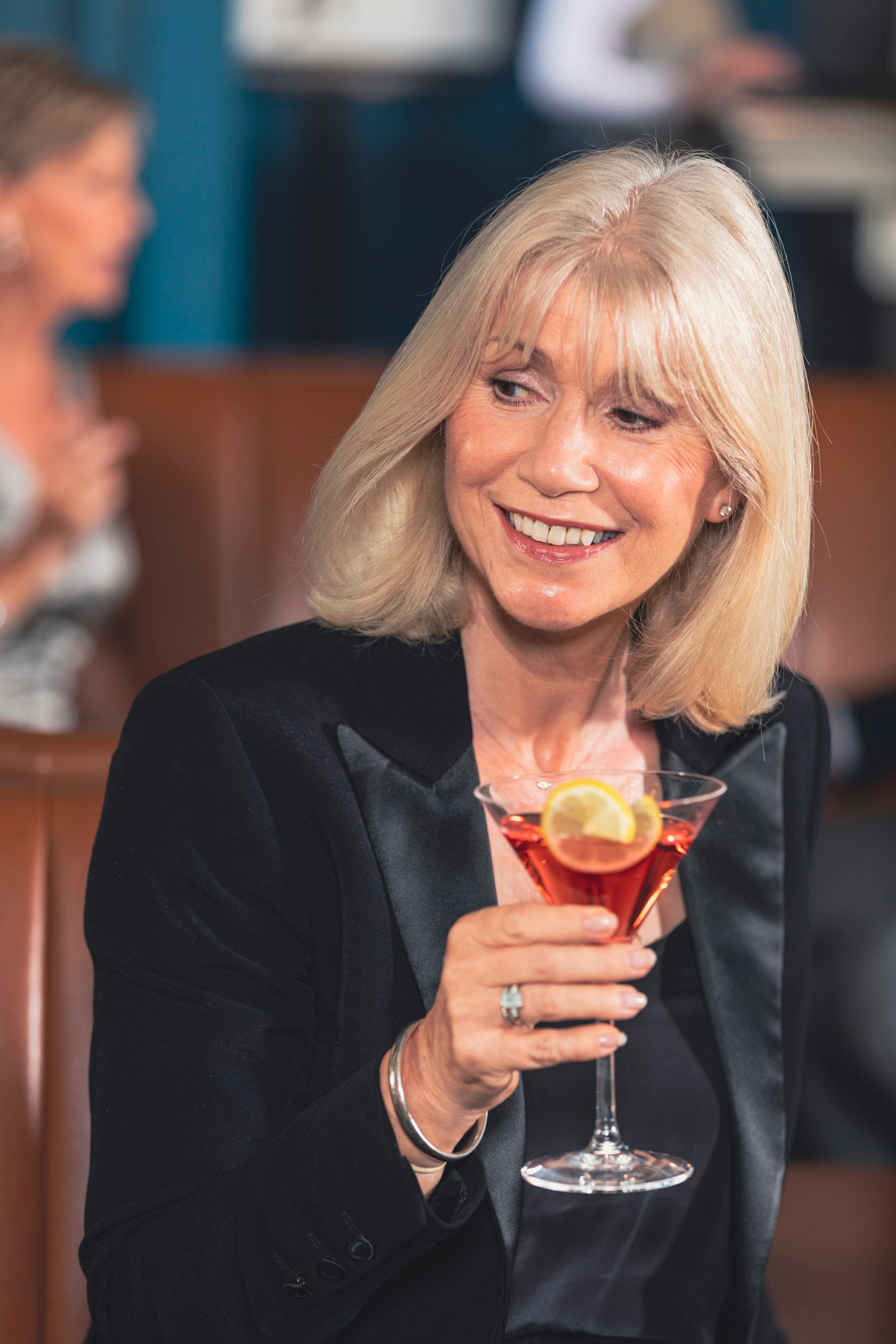 Saga cruise cocktail-bar photography — portrait of a woman in evening wear holding a cocktail