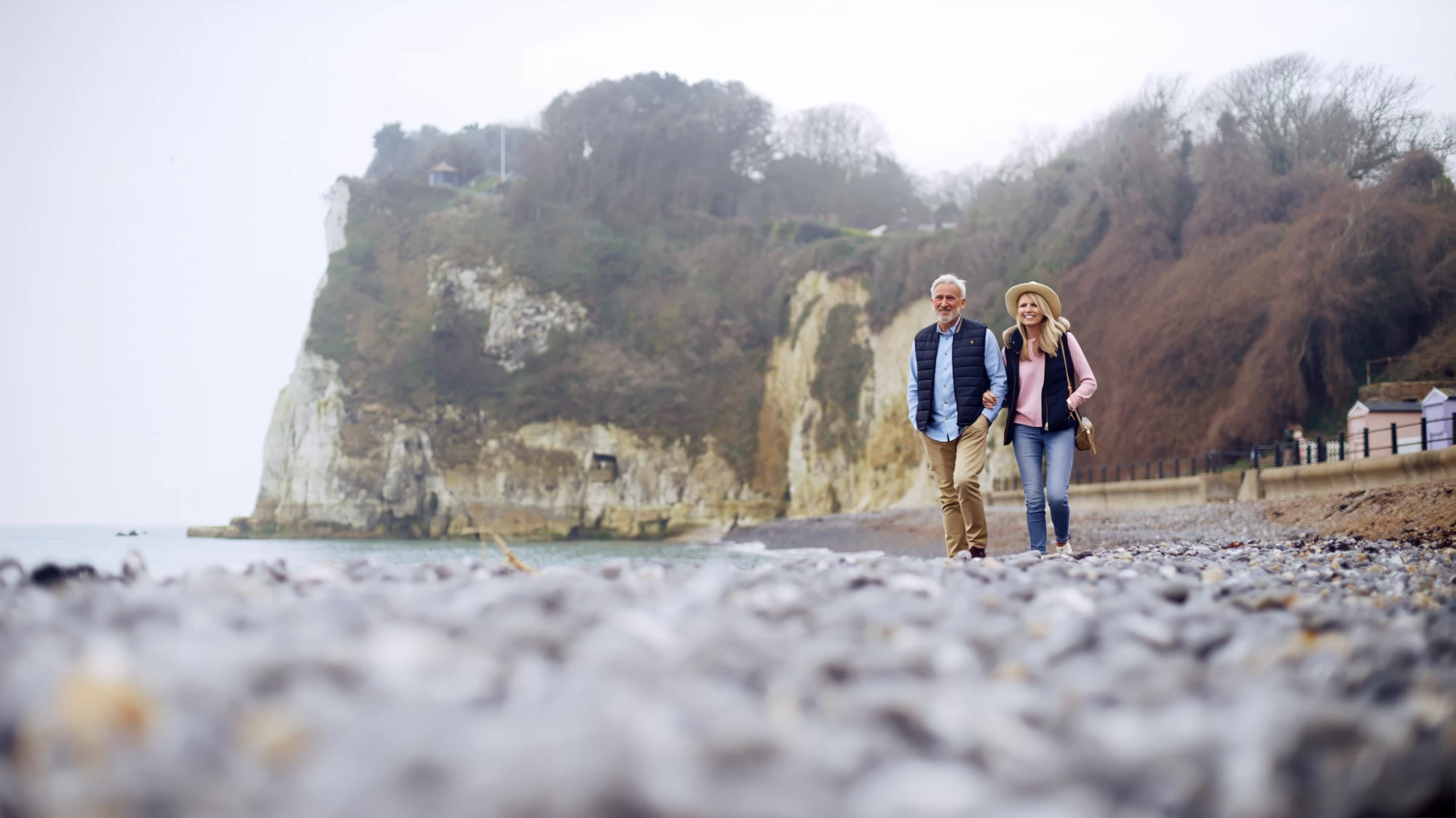 Visit Kent tourism photography — empty-nester couple walking hand in hand beneath the White Cliffs