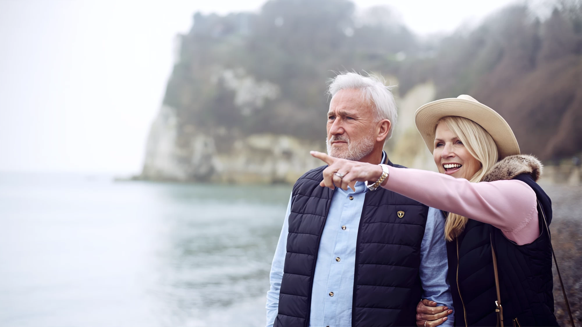 Visit Kent tourism photography — empty-nester couple pointing out to sea from the clifftop path