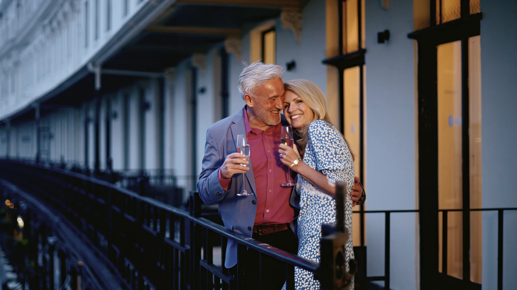 Visit Kent tourism photography — empty-nester couple sharing champagne on a Georgian terrace at dusk