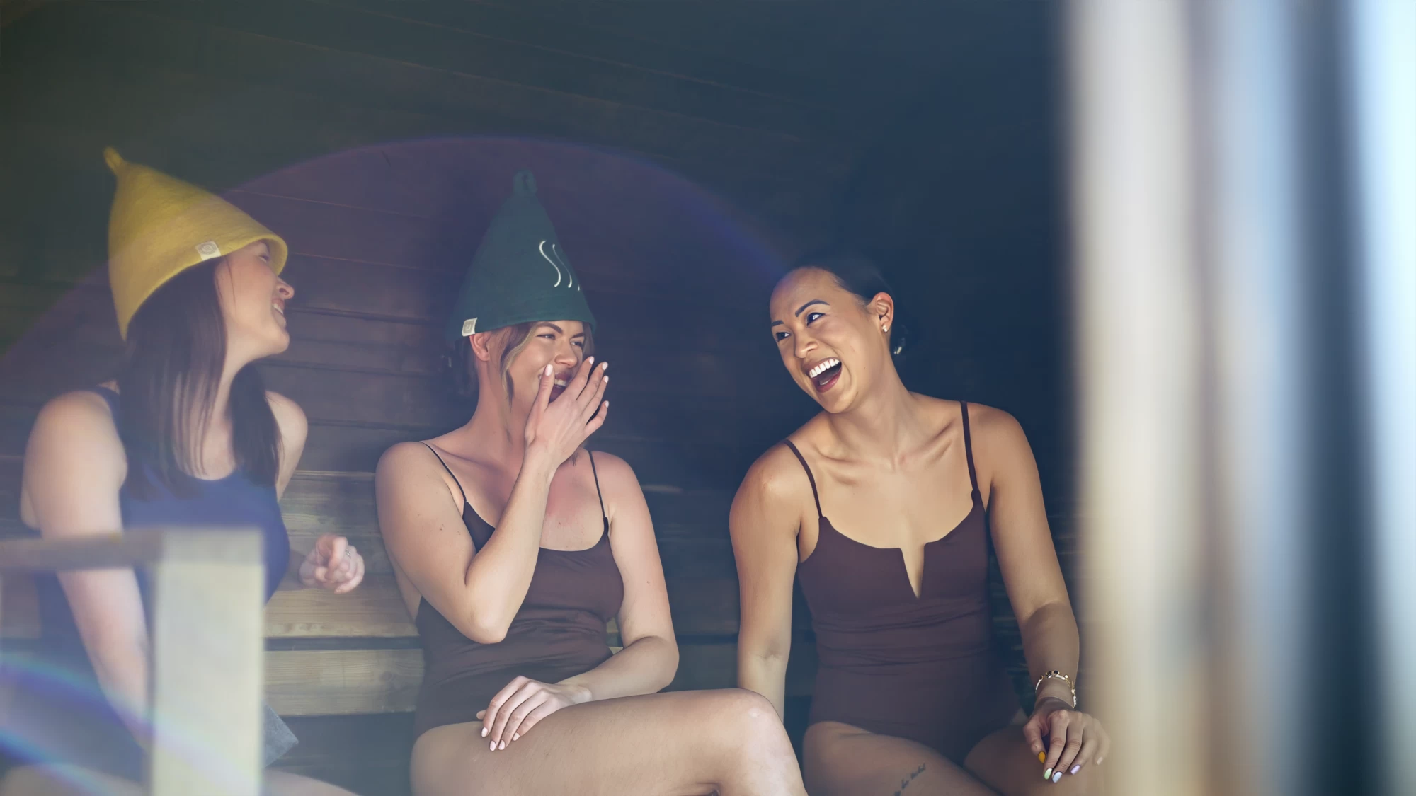 Visit Kent tourism photography — friends laughing together in a coastal sauna